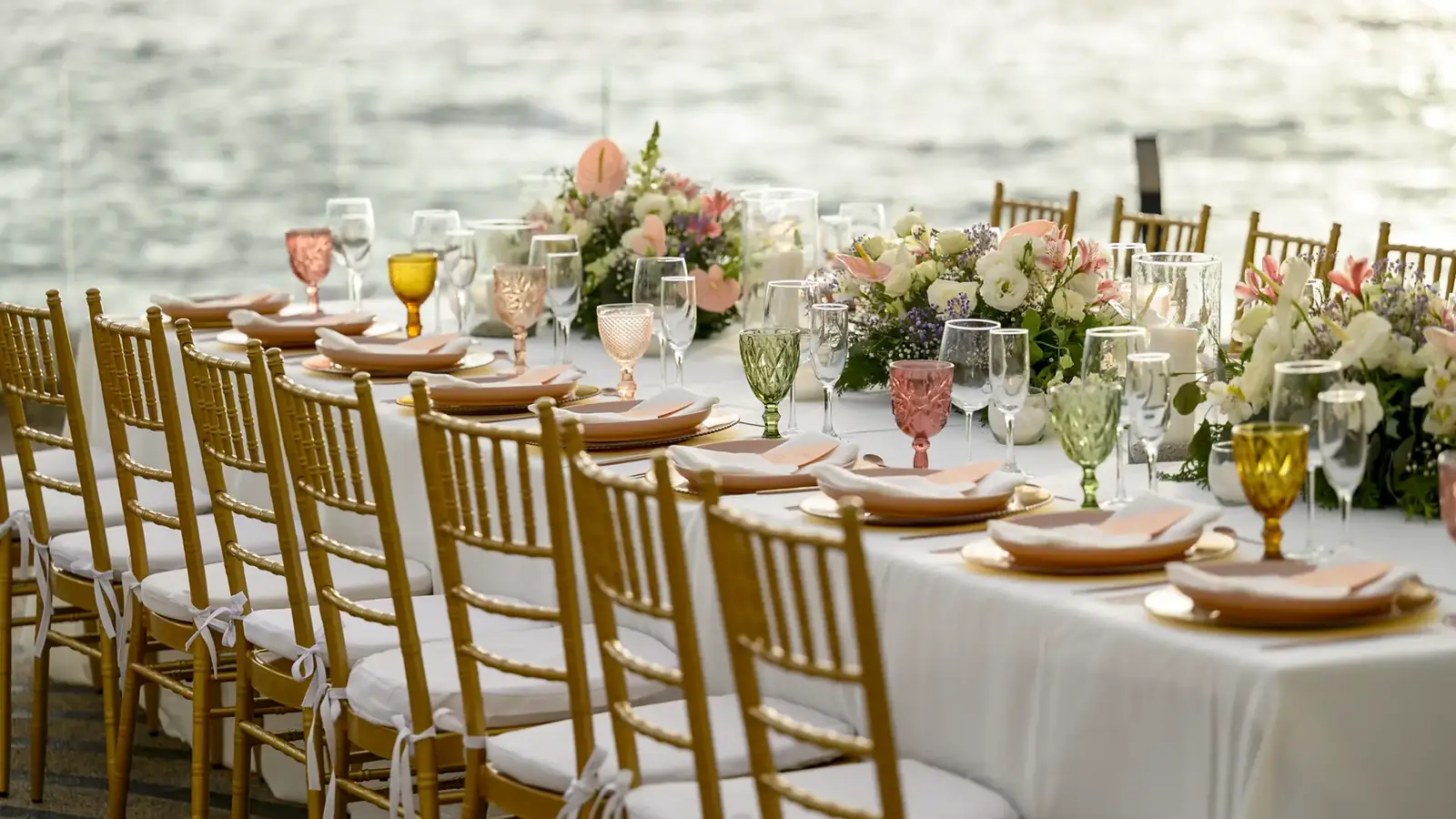 Candlelit reception tables styled on the ocean terrace of a private wedding villa in Puerto Vallarta